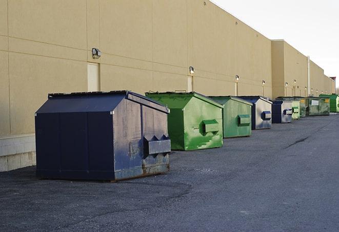 a crowd of dumpsters of all colors and sizes at a construction site in Bonham